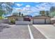 Charming single-story home featuring a large driveway, desert landscaping, and an American flag proudly displayed at 511 E Port Au Prince Ln, Phoenix, AZ 85022
