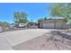 Charming single-story home featuring a large driveway, desert landscaping, and an American flag proudly displayed at 511 E Port Au Prince Ln, Phoenix, AZ 85022