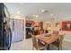 Bright kitchen with a dining area, modern appliances, and an open view to the living area at 511 E Port Au Prince Ln, Phoenix, AZ 85022