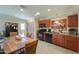 Open-concept kitchen with modern appliances, a spacious table, and ample cabinet space at 511 E Port Au Prince Ln, Phoenix, AZ 85022
