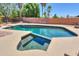 Inviting backyard pool and spa features a diving board, cool decking and privacy wall at 511 E Port Au Prince Ln, Phoenix, AZ 85022