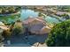 Stunning aerial view of waterfront property, showcasing lush landscaping and community lake at 5281 W Quail Ave, Glendale, AZ 85308