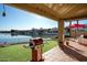 Outdoor patio with artificial grass, a lake view, a BBQ, and string lights for outdoor entertaining at 5281 W Quail Ave, Glendale, AZ 85308