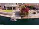A tranquil waterfront scene with a private dock, boat, and lush landscaping at 5281 W Quail Ave, Glendale, AZ 85308