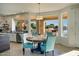 Dining area with backyard view, modern chandelier, and stainless steel appliances at 5281 W Quail Ave, Glendale, AZ 85308