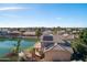 Waterfront home with solar panels, a patio, and picturesque landscaping along the tranquil lake at 5281 W Quail Ave, Glendale, AZ 85308