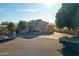 Beautiful home with a well-manicured lawn, mature trees, and a circular driveway at 5281 W Quail Ave, Glendale, AZ 85308