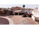Beautiful lakefront home with a manicured lawn, flowering bushes and a three-car garage at 5281 W Quail Ave, Glendale, AZ 85308