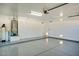 Spacious and well-lit garage with epoxy flooring provides ample space for vehicles and storage at 5281 W Quail Ave, Glendale, AZ 85308