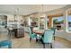 Eat-in kitchen area with blue chairs, granite countertops, and modern stainless steel appliances at 5281 W Quail Ave, Glendale, AZ 85308