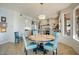 Eat-in kitchen area with blue chairs, granite countertops, and modern stainless steel appliances at 5281 W Quail Ave, Glendale, AZ 85308