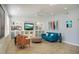 Open-concept living room features built-in shelving, TV, and a cozy blue sofa at 5281 W Quail Ave, Glendale, AZ 85308