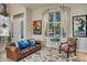 Inviting living room boasting a comfortable leather sofa and a large window with plantation shutters at 5281 W Quail Ave, Glendale, AZ 85308