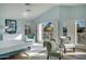 Bright main bedroom with light blue walls, light wood floors, and a view of the lake at 5281 W Quail Ave, Glendale, AZ 85308
