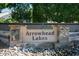 Community entrance sign for Arrowhead Lakes with decorative stone and desert plants at 5281 W Quail Ave, Glendale, AZ 85308
