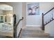 Carpeted staircase leads to upper level, featuring decorative art and natural light at 5281 W Quail Ave, Glendale, AZ 85308