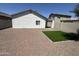 Low-maintenance backyard features gravel and small patch of synthetic grass, perfect for relaxing and entertaining at 5635 S 11Th Dr, Phoenix, AZ 85041