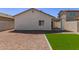 View of the backyard with gravel landscaping and a patch of artificial turf at 5635 S 11Th Dr, Phoenix, AZ 85041