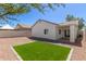 Low maintenance backyard with artificial grass and an extended covered patio at 5635 S 11Th Dr, Phoenix, AZ 85041