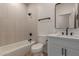 Modern bathroom featuring a vanity, large mirror, and combination shower-tub at 5635 S 11Th Dr, Phoenix, AZ 85041