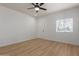 Bright bedroom with wood-look floors, modern ceiling fan, and convenient exterior access at 5635 S 11Th Dr, Phoenix, AZ 85041
