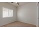 Inviting carpeted bedroom with plenty of light, and a ceiling fan at 5635 S 11Th Dr, Phoenix, AZ 85041