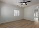 Spacious, light-filled bedroom featuring wood-look floors and a modern ceiling fan at 5635 S 11Th Dr, Phoenix, AZ 85041