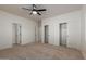 Bright bedroom featuring a ceiling fan and closet, offering ample storage at 5635 S 11Th Dr, Phoenix, AZ 85041
