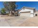 Single-story home with a two-car garage and desert landscaping for easy upkeep at 5635 S 11Th Dr, Phoenix, AZ 85041