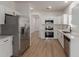 Modern kitchen with stainless steel appliances, white cabinetry, and ample counter space at 5635 S 11Th Dr, Phoenix, AZ 85041