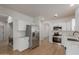 Updated kitchen boasts stainless steel appliances, sleek white cabinets, and modern design at 5635 S 11Th Dr, Phoenix, AZ 85041
