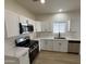 Modern kitchen featuring stainless steel appliances, white cabinets, and countertops, perfect for cooking at 5635 S 11Th Dr, Phoenix, AZ 85041