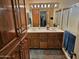 Bathroom featuring a dual sink vanity, ample cabinet space, and a separate shower at 5728 E Dodge St, Mesa, AZ 85205