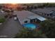 Aerial view of backyard featuring a pool, gravel landscaping, and covered patio at 5735 S Cloverdale Ln, Gilbert, AZ 85298