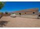 Spacious gravel backyard featuring a covered vehicle and a well-maintained exterior at 5735 S Cloverdale Ln, Gilbert, AZ 85298