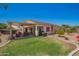 Beautifully landscaped backyard featuring a covered patio and well-maintained lawn at 5735 S Cloverdale Ln, Gilbert, AZ 85298