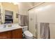 Bathroom featuring a single sink, shower, toilet, and window at 5735 S Cloverdale Ln, Gilbert, AZ 85298