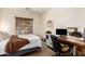 Cozy bedroom with a large window for natural light, desk, and vanity area at 5735 S Cloverdale Ln, Gilbert, AZ 85298