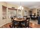 Inviting dining area with a wooden table, upholstered chairs, a chandelier, and natural light at 5735 S Cloverdale Ln, Gilbert, AZ 85298