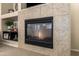 Close-up of the cozy gas fireplace with tile surround and built-in shelving at 5735 S Cloverdale Ln, Gilbert, AZ 85298
