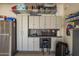 Well-organized garage featuring ample storage with built-in cabinets and overhead shelving at 5735 S Cloverdale Ln, Gilbert, AZ 85298