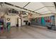 Spacious garage with epoxy flooring, storage cabinets, and well-organized storage shelves at 5735 S Cloverdale Ln, Gilbert, AZ 85298