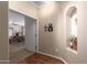 Hallway leading to a bedroom, featuring hardwood floors and a decorative niche at 5735 S Cloverdale Ln, Gilbert, AZ 85298