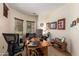 Inviting home office with natural light, wood desk, and comfortable seating for remote work at 5735 S Cloverdale Ln, Gilbert, AZ 85298