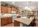 Bright kitchen features granite countertops, stainless steel appliances, a central island with seating, and wood flooring at 5735 S Cloverdale Ln, Gilbert, AZ 85298