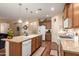 Open kitchen with granite counters, an island with seating, stainless steel appliances, and plenty of cabinet space at 5735 S Cloverdale Ln, Gilbert, AZ 85298