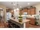 Spacious kitchen with a large island, granite countertops, stainless steel appliances, and pendant lighting at 5735 S Cloverdale Ln, Gilbert, AZ 85298