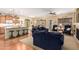 Open concept living room with hardwood floors, fireplace, and kitchen bar at 5735 S Cloverdale Ln, Gilbert, AZ 85298