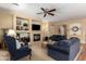 Spacious living room with cozy furniture, ceiling fan, and a tiled fireplace at 5735 S Cloverdale Ln, Gilbert, AZ 85298