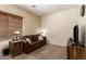 Cozy living room showcasing a comfortable sofa, wood blinds, and tasteful decor at 5735 S Cloverdale Ln, Gilbert, AZ 85298